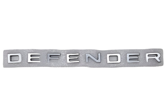 Land-Rover-Aftermarket-LR130733-Rear-Tailgate-Emblem-(DEFENDER)(Thin)(Gray)-DEFENDER-L663